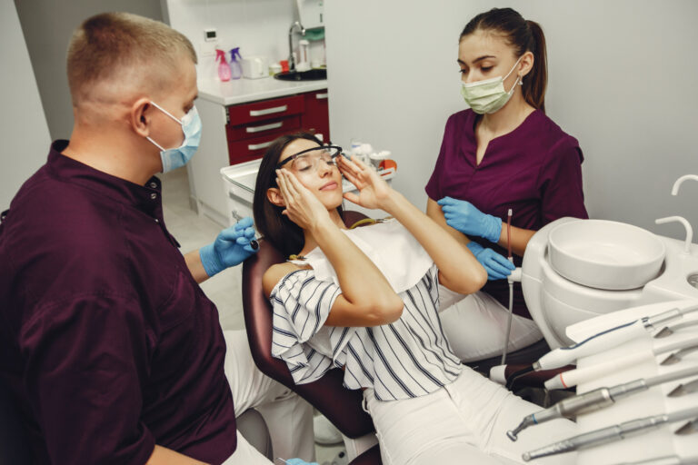 Dentist providing pain-free and gentle dental treatment to help reduce dental fear.