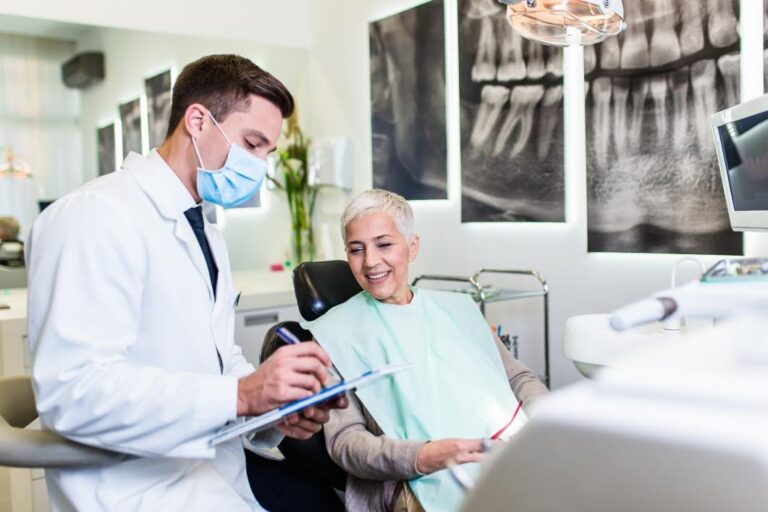 Dentist explaining dental treatment plan to a senior woman patient in a modern dental clinic