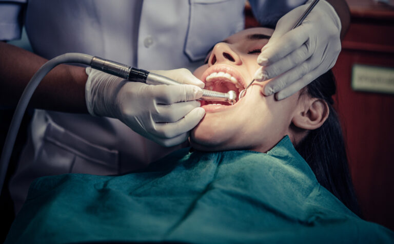 “Dentist performing a tooth filling procedure using modern dental instruments.”