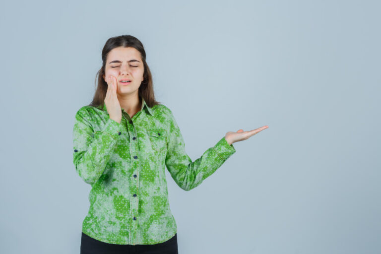 "Person holding jaw due to severe toothache requiring immediate dental visit"