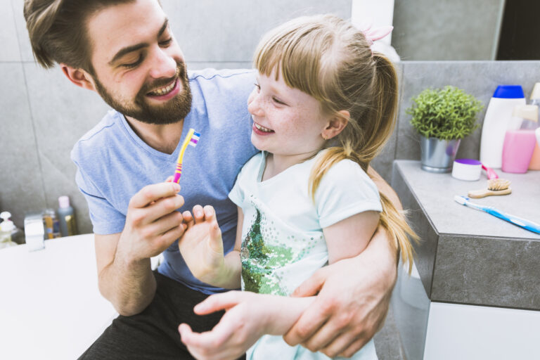 Parent explaining dentist visit to child at home in a positive way